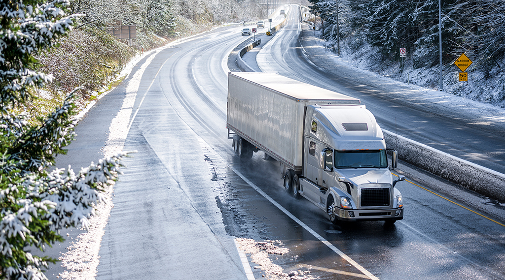 semi trailer driving on winter snowy highway